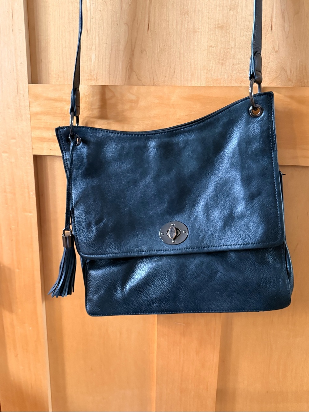 Classic Black Leather Crossbody Bag with Tassel Accent
